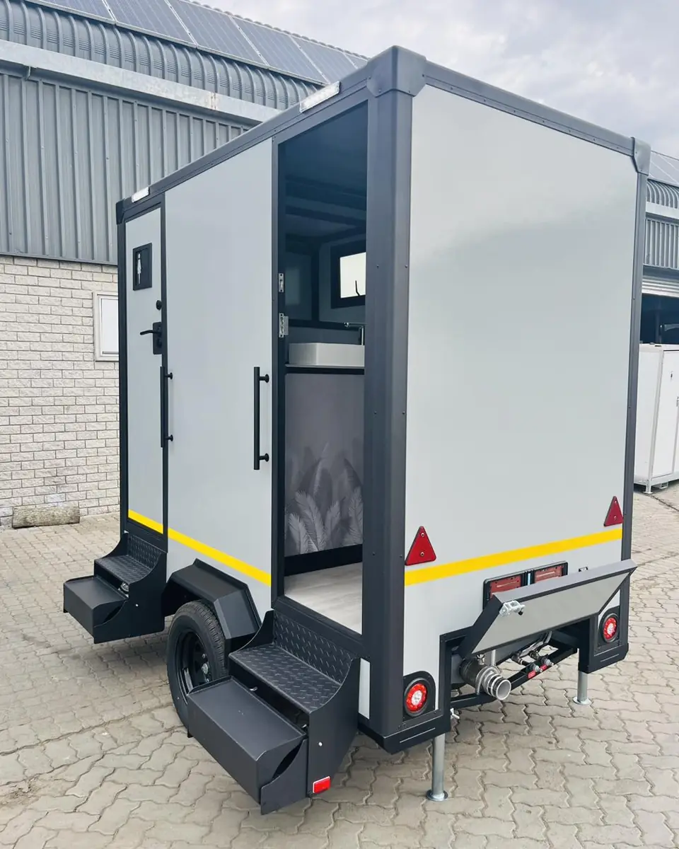 Rear view of a two-station restroom trailer with separate entry doors